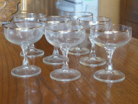 7 Gold rimmed champagne coupes and 5 wine glasses