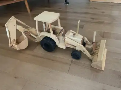 This backhoe handcrafted from scaled drawings is approximately 23” long. As in the real thing, this...
