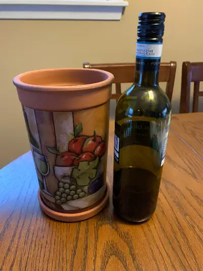 Decorative clay wine cooler. Keeps your chilled bottle of wine cool as it sits at the dinner table.