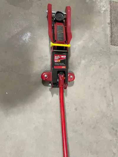 This is a used Big Red 2-ton hydraulic trolley jack, perfect for your automotive needs. It has a 2-t...