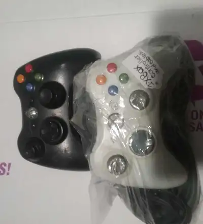 I'm selling a black and white Xbox 360 controller, ideal for enhancing your gaming experience on you...