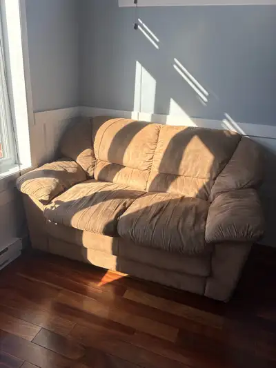 Upgrade your living space with this comfortable pre-owned tan microfiber sofa and loveseat set, offe...