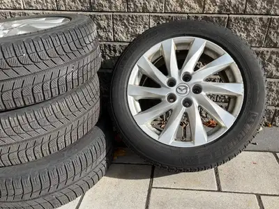 Set of 4 Michelin winter tires for Mazda 6, on original Mazda alloy rims. Tire specs are 215/55R17,...