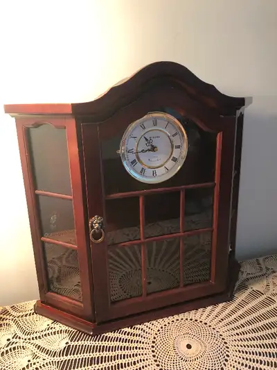 Glass display cabinet with door, shelves and clock. Wall mountable, hanging display cabinet. 20.5” t...