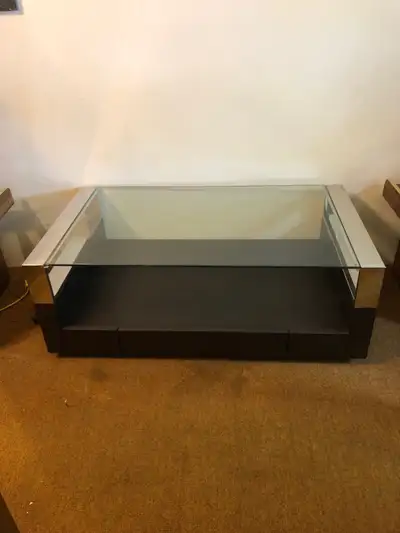 Glass, metal and wood coffee table with drawer. Measurements are: 50 inches (1270 cm) wide x 28 inch...