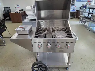All stainless steel prooane BBQ on rugged casters with attached shelf. Total width 4ft, 27" x 21" co...