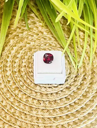 This is a beautiful, cushion cut Rhodolite Garnet gemstone, certified by the NGJA (National Gem and...