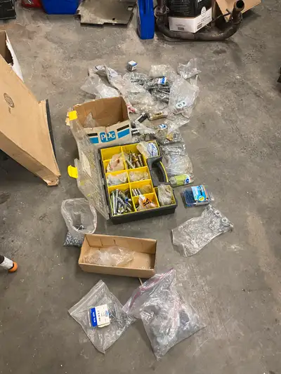 Assortment of concrete, anchors and large nuts and bolts, View more