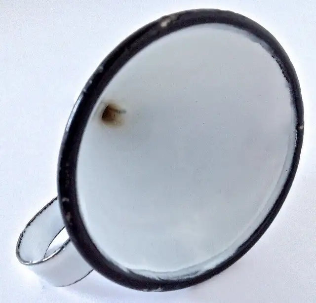 Antiquity. Collection. Old white enameled iron funnel63436969805571123