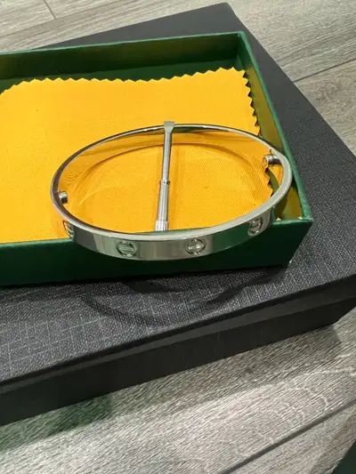 This is a stylish Cartier bracelet, perfect for adding a touch of elegance to any outfit. It is in e...