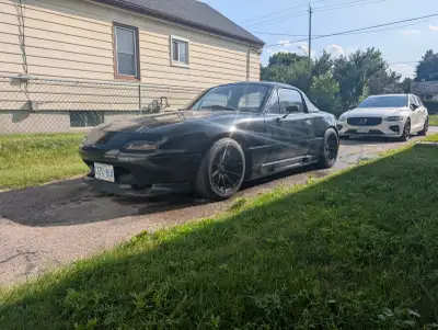 1992 black and tan Mazda Miata for sale. I've owned the car and bought it with a little over 200k 9...