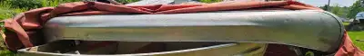 This is a used 16-foot aluminum canoe, perfect for leisurely paddles on the lake. While it shows sig...