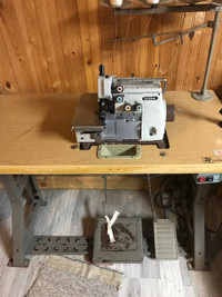 Industrial Brother 4 thread serger mounted on table.