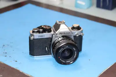 Nikon FM2 with Tokina 28mm lens Clean tested and working Pickup at Computech Camera