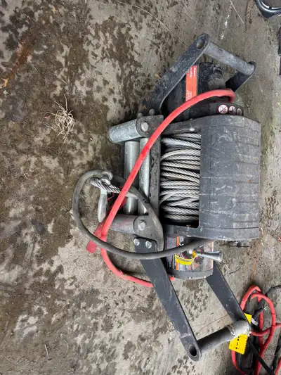 12,000 lb champion winch with synthetic rope 10,000 lb snap on winch. Does not have a remote, new on...