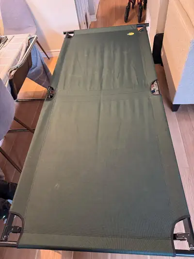 This is a Bass Pro Shops brand camping cot, perfect for outdoor adventures or as a temporary sleepin...