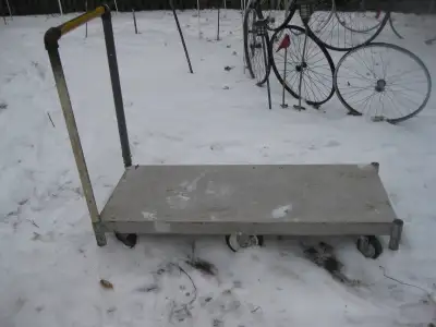 Swivel wheels on both ends. Straight wheels in center. Deck measures 45.75-47.5" L X 88.5-19.5" W X...