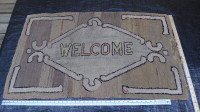 Antique hooked rug with 'Welcome" Motif.