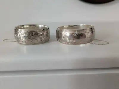 Two gorgeous, timeless Birks sterling silver vintage cuffs, half engraved with safety chains still i...