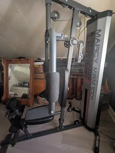 Universal gym with up to 140lbs. Comes with multiple different attachments. Cable sheathing has some...