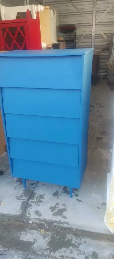 This charming five-drawer dresser has been given a new lease on life with a vibrant blue exterior an...
