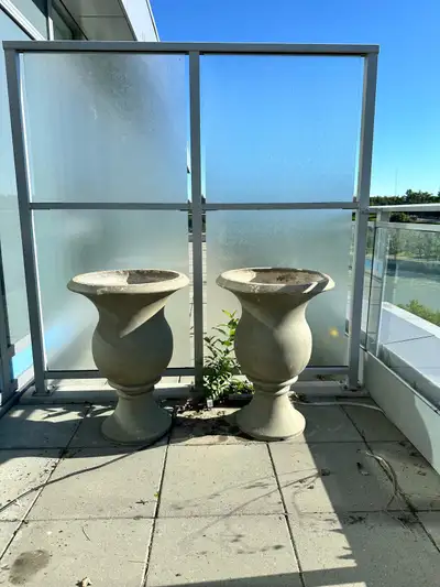 Matching set of two heavy-duty concrete urn planters in a classic baluster pedestal design. Great fo...