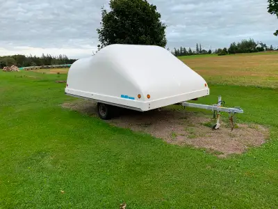 12 ft pop up snowmobile trailer. The top is fibreglass and the frame is galvanized steel. The tires,...
