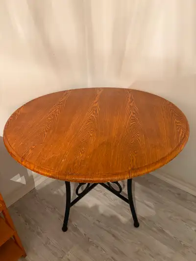 Round dining table with wrought iron base, View more