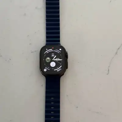 Excellent Apple Watch Ultra 2 49mm. Watch has titanium case with dark blue ribbed band. Watch is ful...
