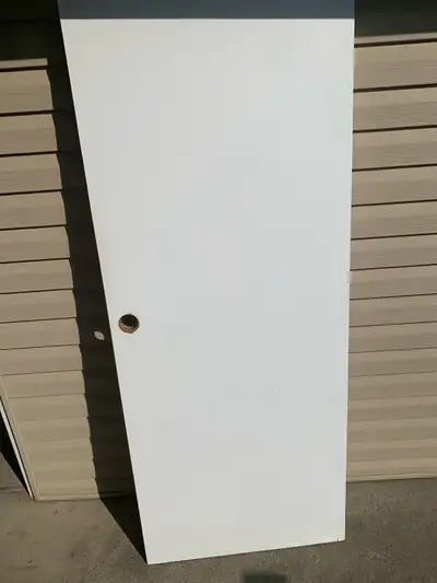 29 3/4” x 74”. Not solid but a little heavier than the doors of today.