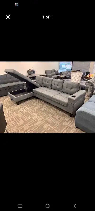 This is a Brand newgrey fabric sectional sofa with a storage chaise and cup holders, perfect for a l...