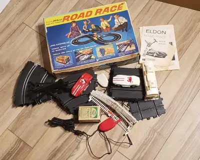 Made in the early 1960s (vintage), this slot car set includes 2 racing cars, track, 2 remote control...