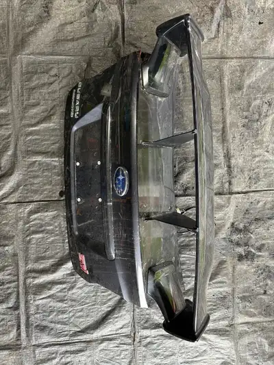 We have a used 2015-2021 Subaru WRX STi OEM Trunk/Spoiler with Wing Stabilizer in Dark Grey Metallic...