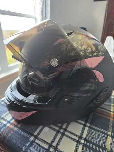 This is a modular motorcycle helmet featuring a Mossy Oak Break-Up Country Pink Camo design; size is...