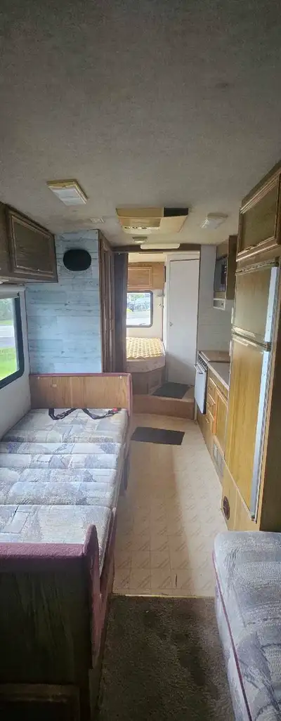 This motorhome offers a cozy living space, perfect for road trips. While it shows signs of use, it's...