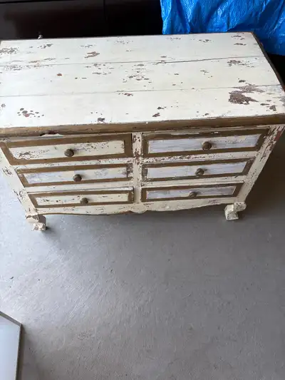 This charming, distressed antique chest of drawers is a unique find, perfect as a side table or acce...