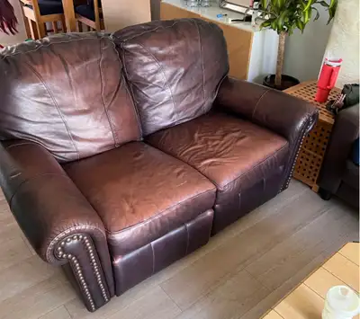 Brown leather lazy boy recliner, good condition, one of the recliners is a little sticky but both wo...