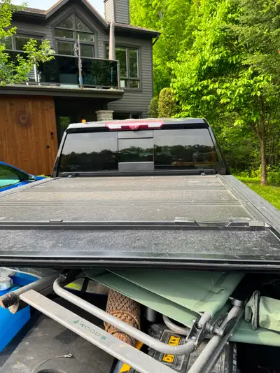 REV Hard tonneau cover for truck bed, 8 feet bed folding in 4 pieces, black, average condition. Avai...