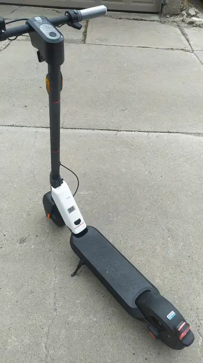 Virtually new, plastic film still on display, comes with charger. This is a good quality scooter. 25...