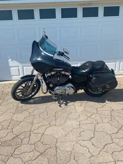 08 Harley Sportster 1200 low. The bike has -12” bars. -Dakota digital speedometer. -Quick detach Mem...