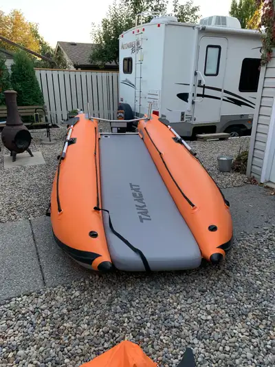12.5’ 4 chamber Inflatable catamaran with inflatable floor. Comes with oars, transom wheels, rod hol...