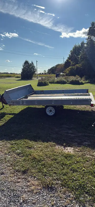 Two place galvanized tilt snowmobile trailer with new tires last season. No ownership lost it. Tows...