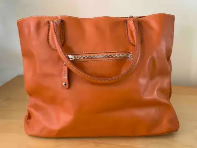 Roots Orange leather tote bag $79, View more