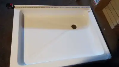 Brand new - Solid acrylic corner shower base - see the picture for dimensions - 36 x 48 inches.