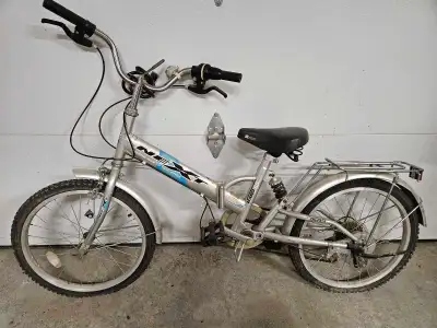 This is a Next folding bike with 20-inch wheels, perfect for urban commuting or recreational rides,...