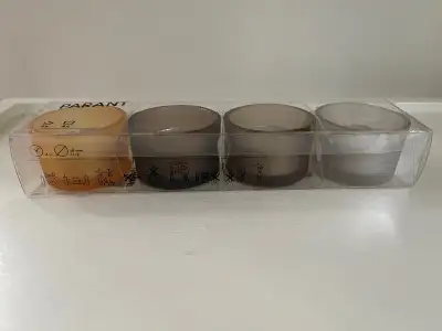 New in sealed box set of four coloured votive candles and holders from IKEA. Pickup at Davisville st...