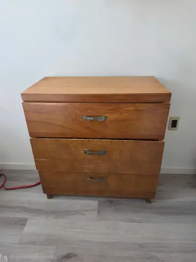 This charming three-drawer wooden dresser is in good condition and is ready to provide sturdy storag...