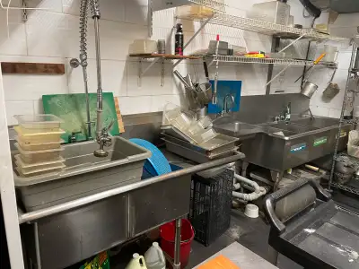 For sale is a collection of used commercial kitchen equipment including a three-compartment sink wit...