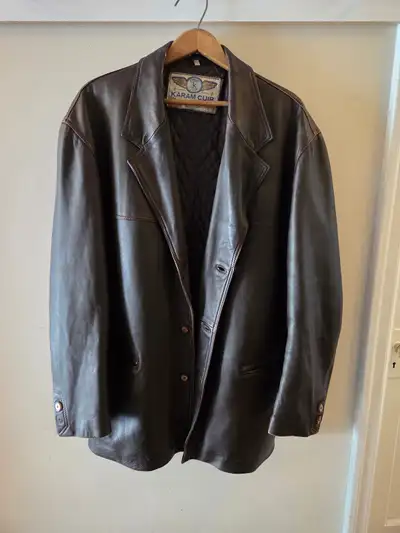 Karam Cuir. Made in Casablanca. Lamb leather. Button close. Medium/dark brown. Inner pockets with zi...