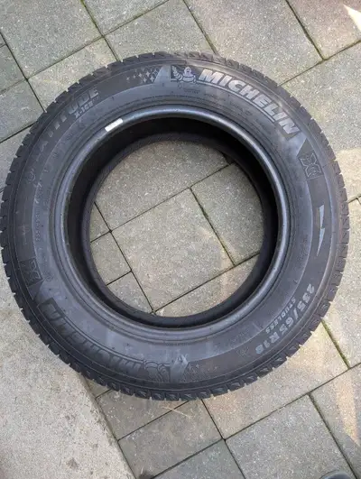 These Michelin Latitude X-Ice winter tires, size 235/65R18, provide exceptional grip and handling in...
